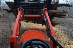 One of our Kioti tractors with grapple moving a 12’x12’ barn floor the burn pile (we tried to reclaim, but it was too far gone).